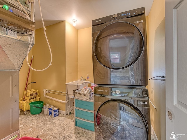 laundry room with stacked washer / drying machine