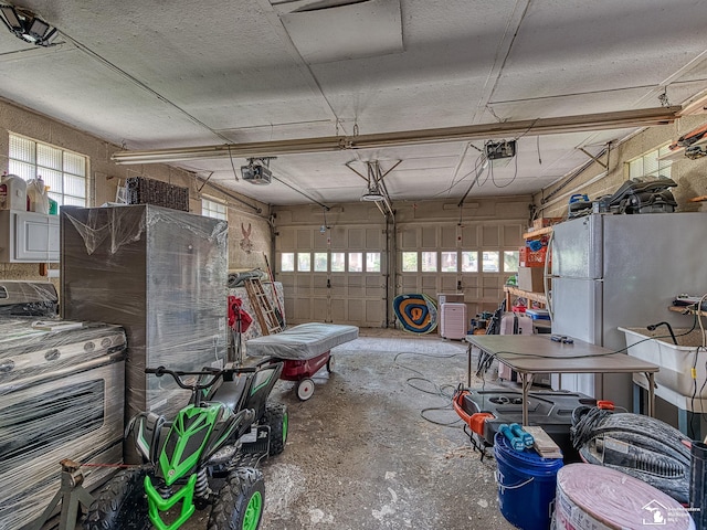 garage with refrigerator and a garage door opener