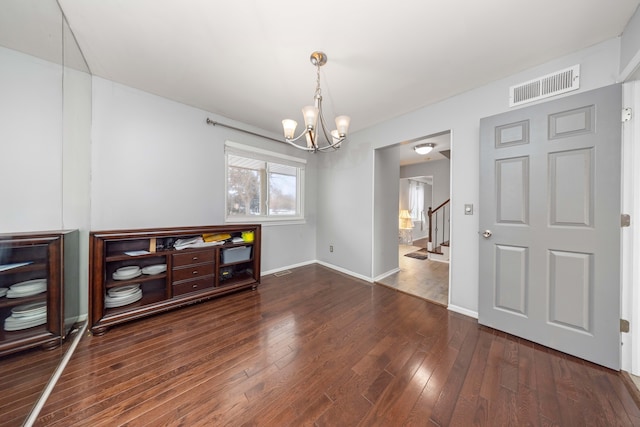 interior space with an inviting chandelier and dark hardwood / wood-style flooring