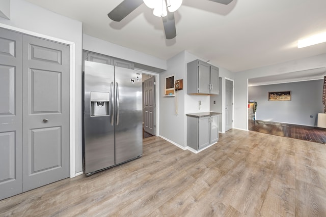 kitchen featuring ceiling fan, light wood-type flooring, stainless steel fridge with ice dispenser, and gray cabinetry