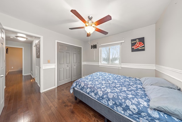 bedroom with ceiling fan, dark hardwood / wood-style floors, and a closet