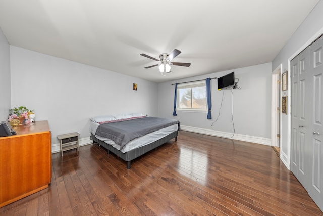 bedroom with ceiling fan, a closet, and dark hardwood / wood-style flooring