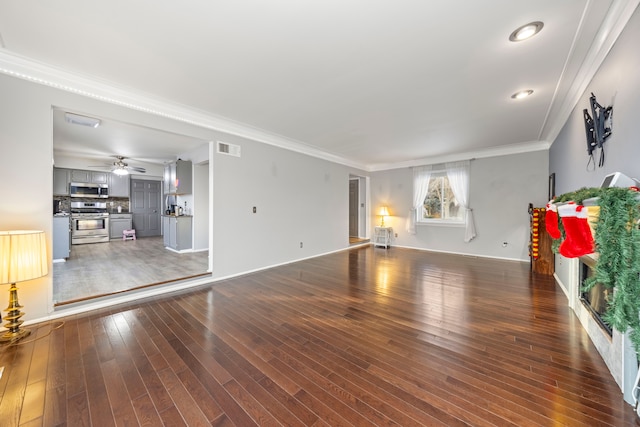 unfurnished living room featuring ceiling fan, dark wood-type flooring, and ornamental molding