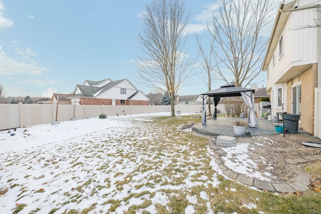 yard covered in snow featuring a gazebo