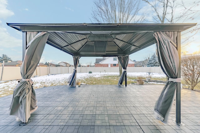 snow covered patio featuring a gazebo