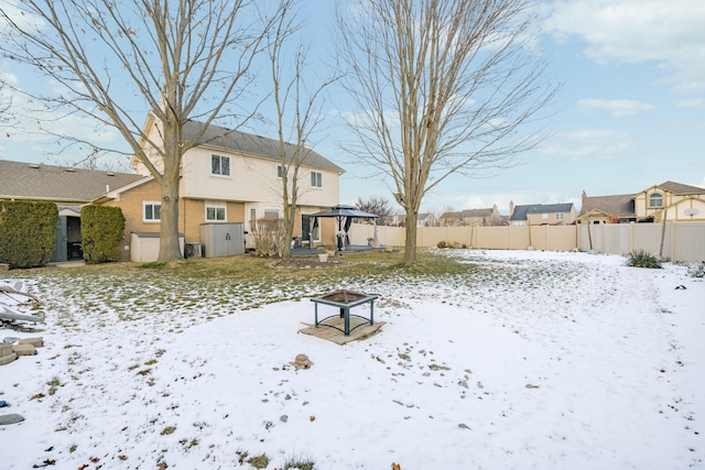 snowy yard with a gazebo