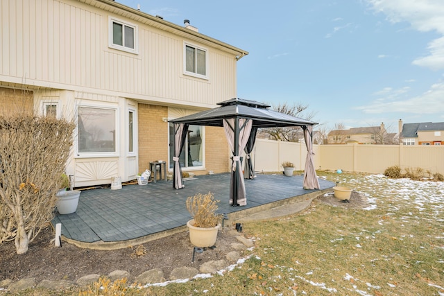 rear view of house featuring a deck and a gazebo