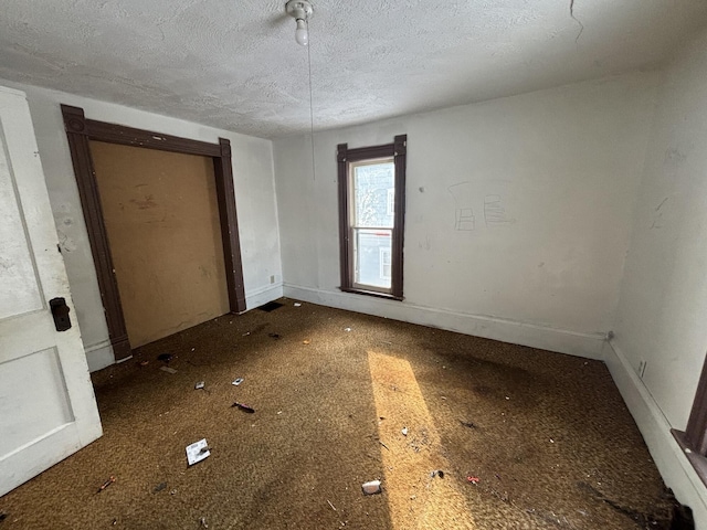 unfurnished room with a textured ceiling