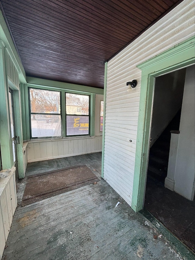 unfurnished sunroom featuring wood ceiling