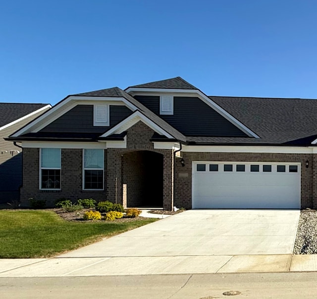 16088 Conifer Ln, Clinton Township, MI 48038 - view of front of property featuring concrete driveway, a front lawn, brick siding, and a garage