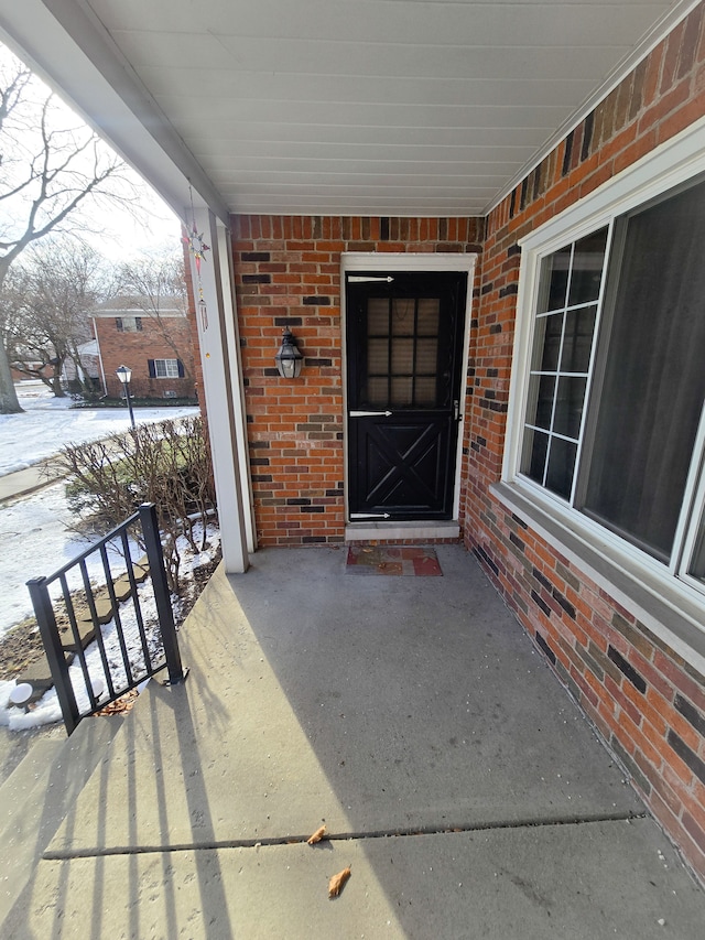 view of snow covered property entrance