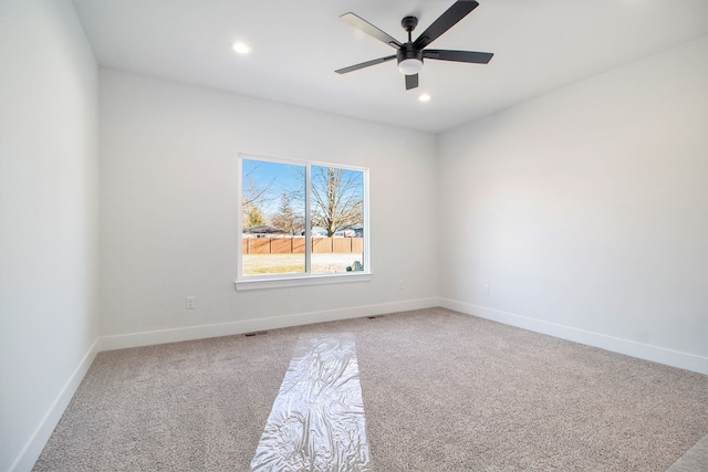 carpeted empty room featuring ceiling fan, recessed lighting, and baseboards