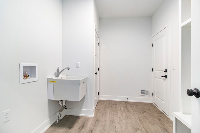 washroom featuring washer hookup, visible vents, light wood-style floors, laundry area, and baseboards