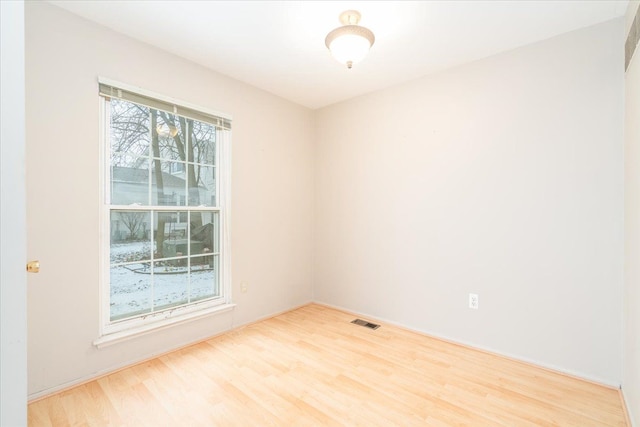 spare room featuring light wood-type flooring