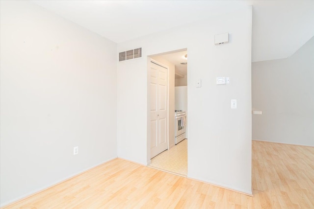 empty room with light hardwood / wood-style floors