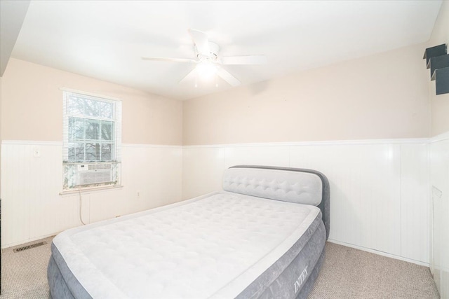 carpeted bedroom featuring cooling unit and ceiling fan