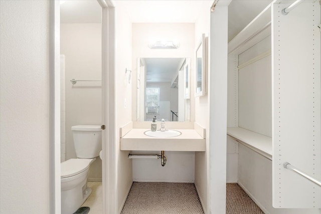 bathroom with sink, tile patterned floors, and toilet