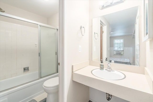 full bathroom featuring tile patterned floors, toilet, sink, shower / bath combination with glass door, and ceiling fan