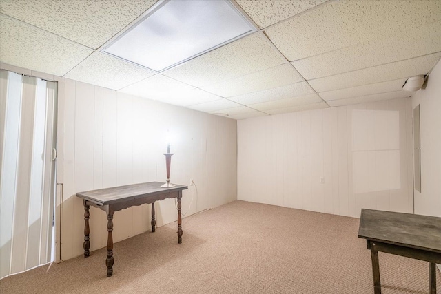 basement with carpet flooring and a drop ceiling