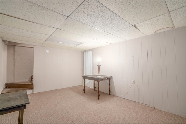 basement with carpet flooring and a drop ceiling