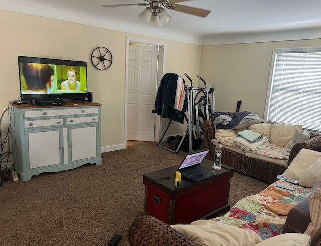 living area with ceiling fan, dark carpet, and baseboards