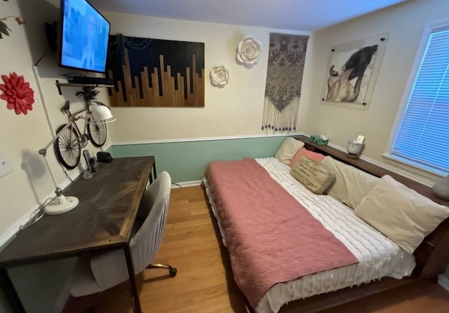 bedroom with light wood-type flooring and baseboards