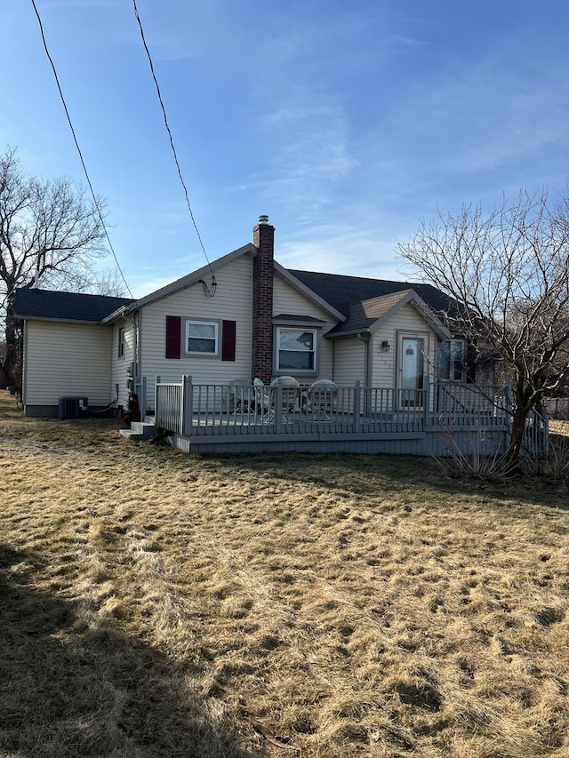 back of property with a deck, central air condition unit, and a chimney