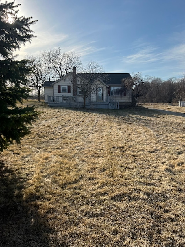 view of front of property featuring a chimney and a deck