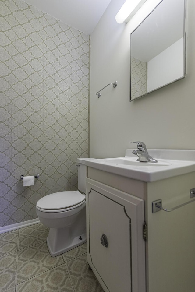 bathroom featuring toilet and vanity