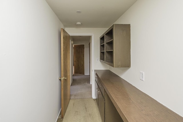 hallway featuring light colored carpet