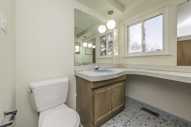 bathroom featuring toilet, vanity, and tile patterned flooring