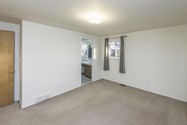 unfurnished room with light carpet