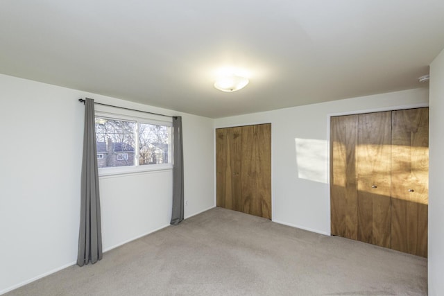 unfurnished bedroom featuring light colored carpet