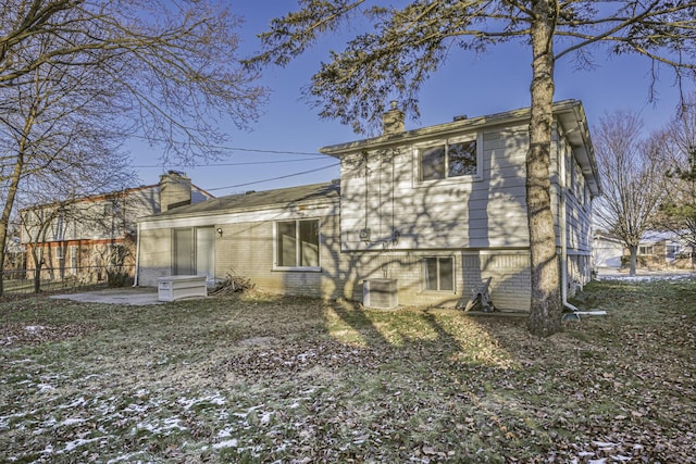 rear view of house with cooling unit and a patio