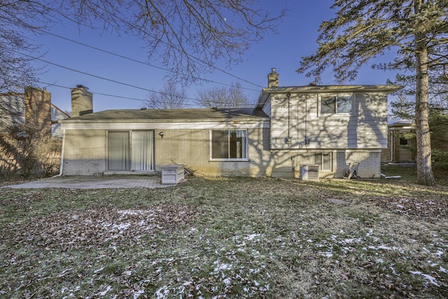 rear view of house with central AC and a patio area