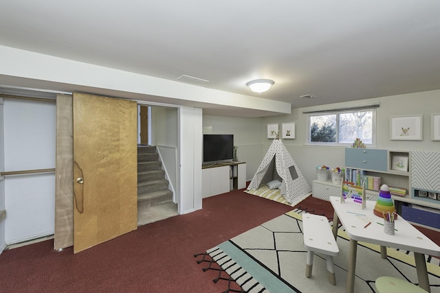 playroom featuring dark colored carpet