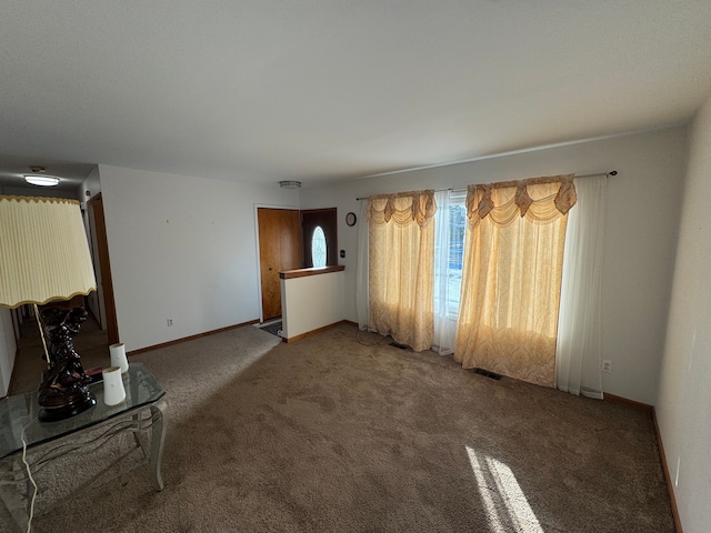 unfurnished living room featuring carpet flooring