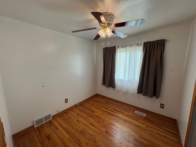 unfurnished room featuring hardwood / wood-style flooring and ceiling fan