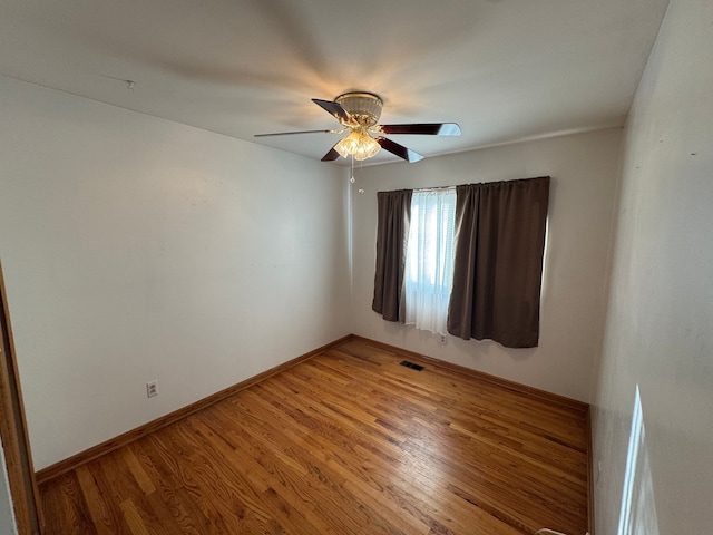 spare room featuring hardwood / wood-style flooring and ceiling fan