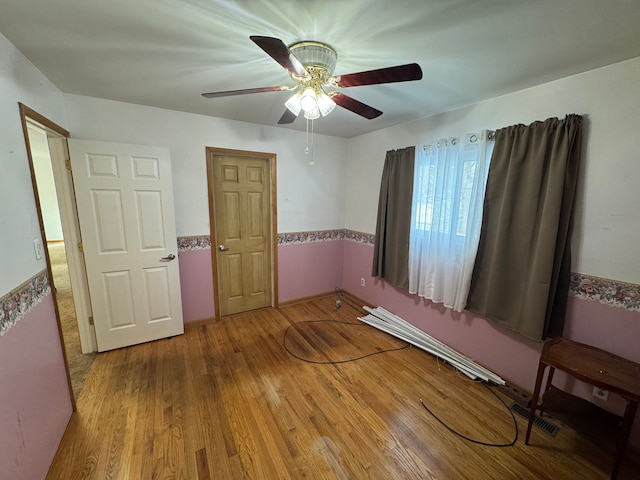 unfurnished bedroom featuring ceiling fan and hardwood / wood-style floors