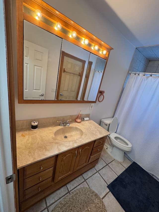 bathroom featuring toilet, a shower with shower curtain, tile patterned floors, and vanity