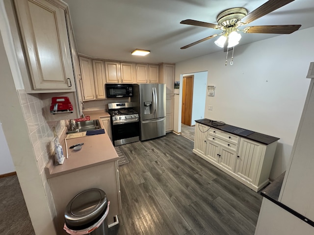 kitchen featuring backsplash, appliances with stainless steel finishes, dark hardwood / wood-style floors, and cream cabinets