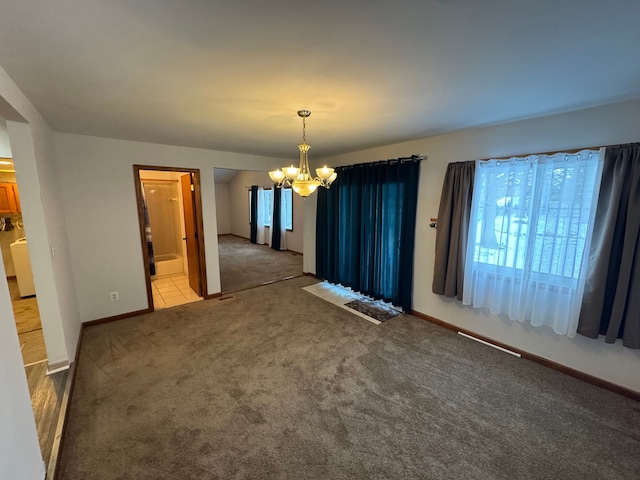 unfurnished dining area with carpet floors and an inviting chandelier