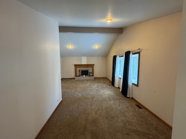 unfurnished living room with a brick fireplace, carpet, and lofted ceiling with beams