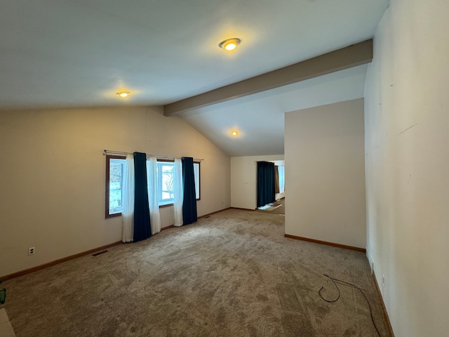 carpeted spare room featuring lofted ceiling with beams