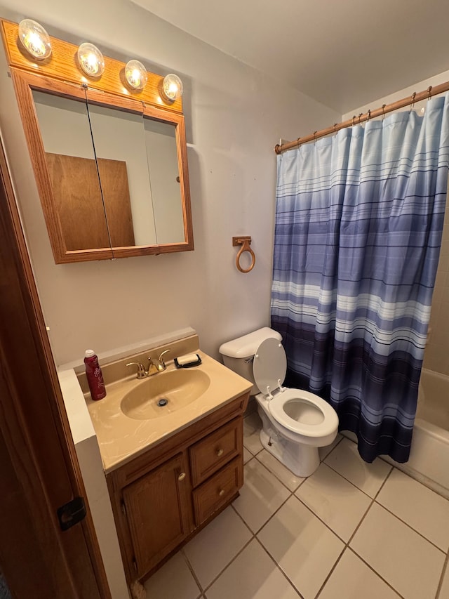 full bathroom with shower / bath combo with shower curtain, toilet, vanity, and tile patterned flooring