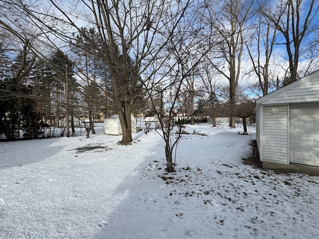 view of yard layered in snow