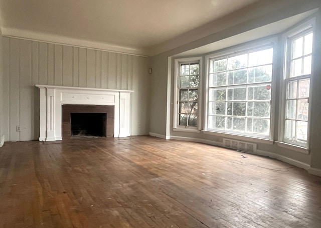 unfurnished living room featuring hardwood / wood-style floors and a fireplace