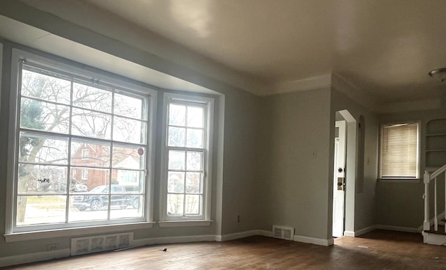 interior space with a healthy amount of sunlight and hardwood / wood-style floors