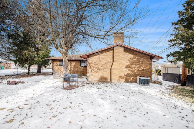 snow covered property featuring central air condition unit